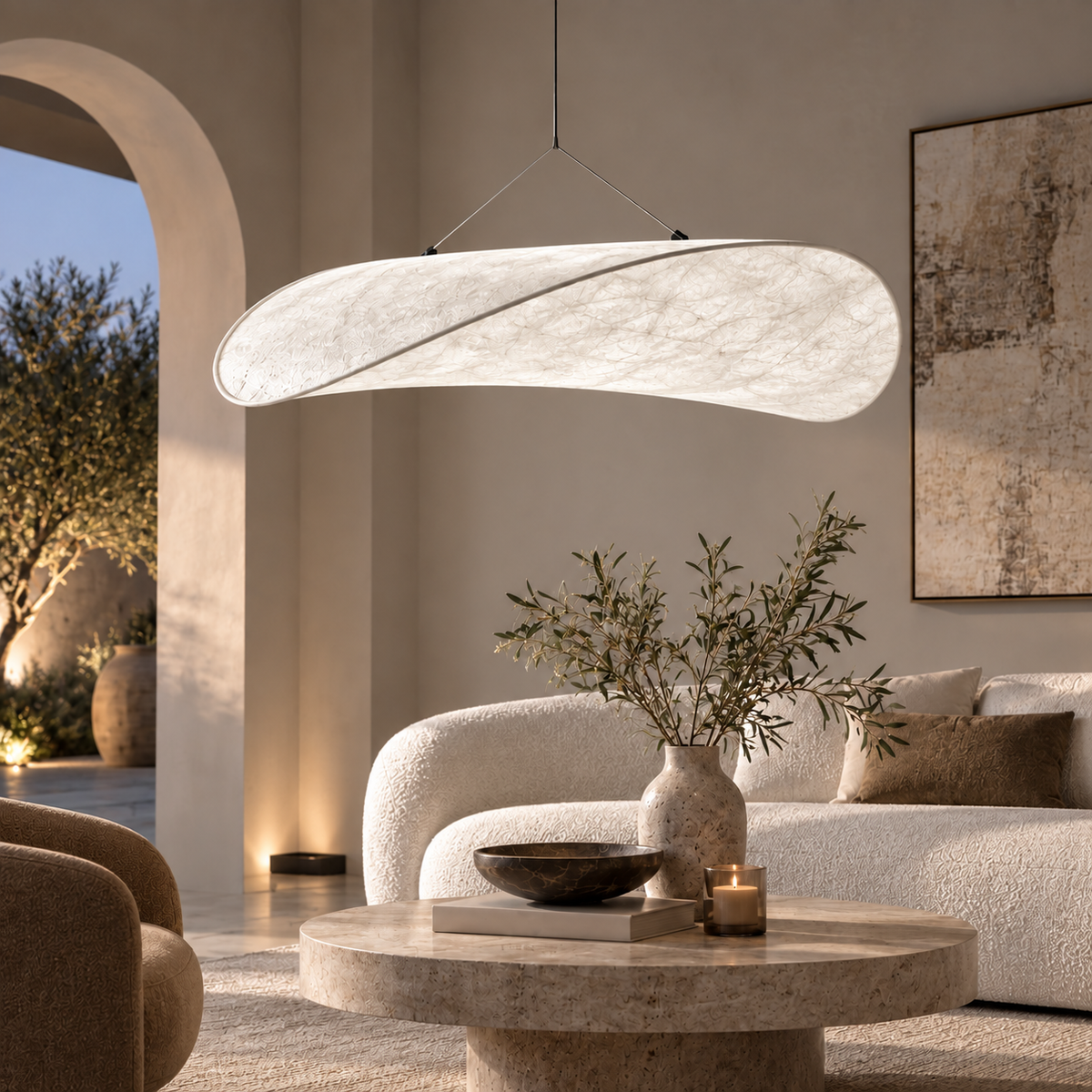 Onda textile pendant casting neutral white light over a living room seating area